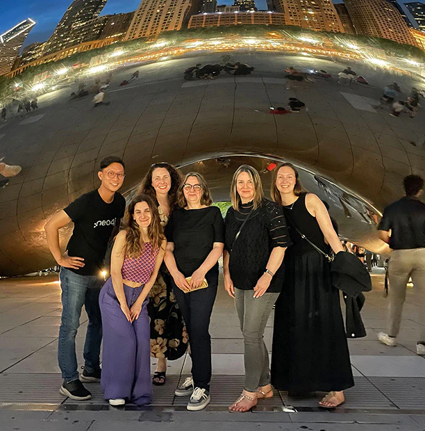 Marketing team members posing in front of the Chicago Cloud Gate during an offsite.