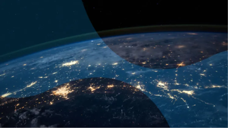 City lights spread across a continent, seen from orbit at night