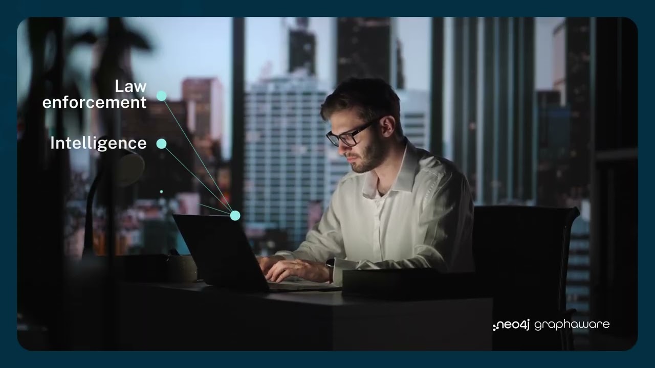 Analyst working at a laptop with law enforcement and intelligence data points connected